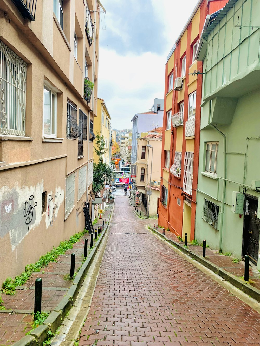 a narrow brick street with buildings on both sides