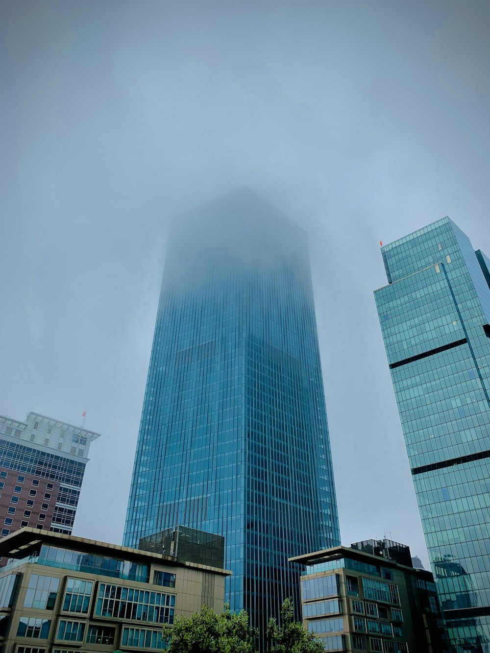 a very tall building surrounded by other tall buildings