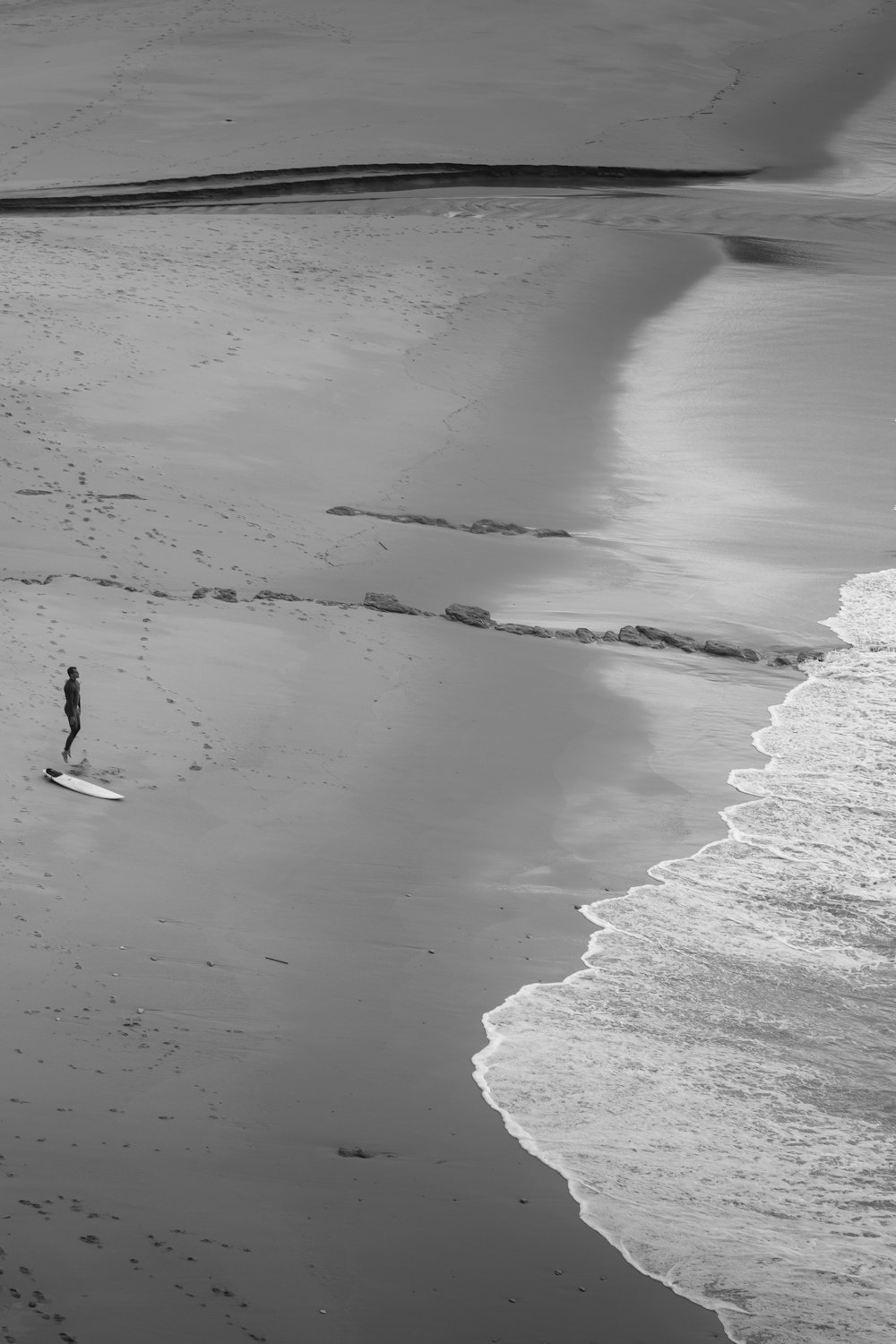 a person standing on a beach next to the ocean