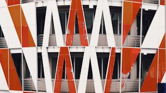 Exterior shot of a building featuring a complex pattern of red, white, and black paint finishes