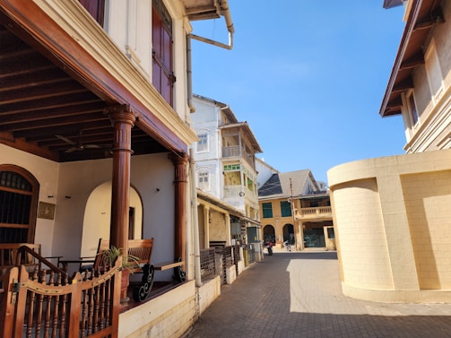 A quiet street lined with colonial-style buildings under a soft blue sky in Tlalpan.