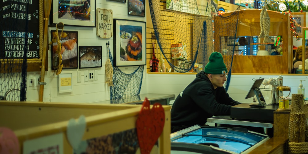 a man sitting at a desk in a store