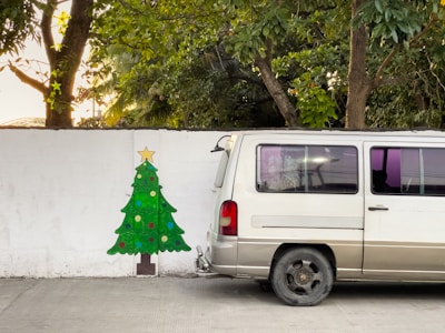 Delivery van parked in front of a cozy home with a freshly delivered Christmas tree.