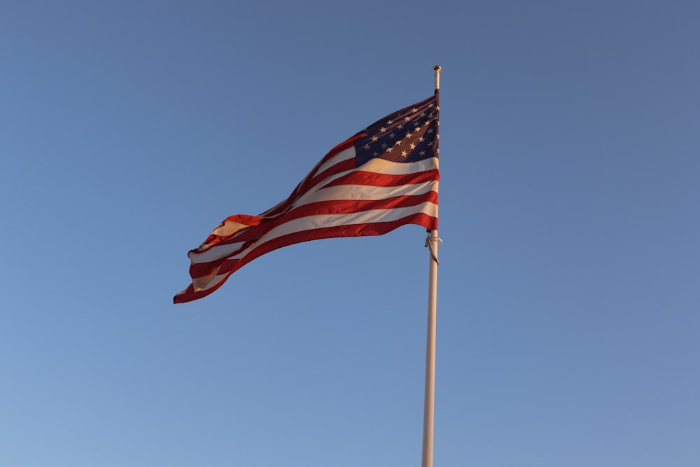 an american flag is flying high in the sky