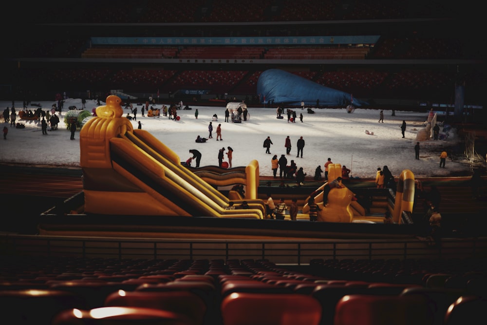 a large inflatable slide in a stadium filled with people
