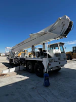 Mobile welding truck parked beside a large crane undergoing structural reinforcement.