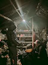 A cozy gathering of collectors sharing and trading their prized items in a warm, inviting space.