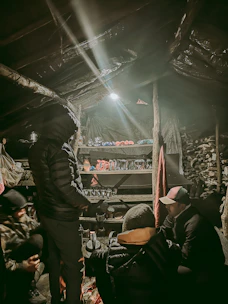 A group of Calabrian producers and cultural operators collaborating in a warm, rustic setting.