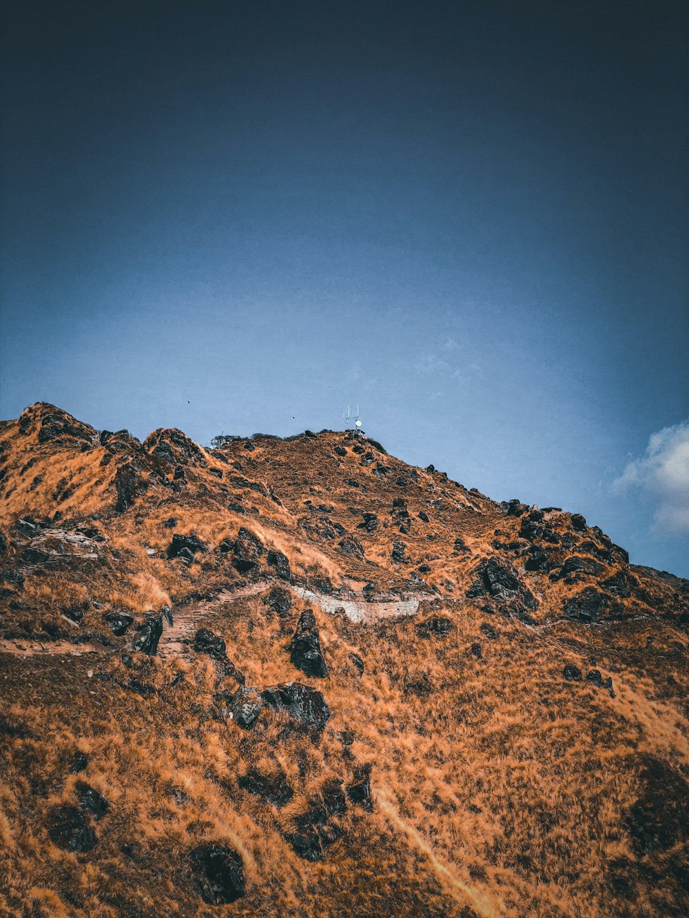 a very tall mountain with a sky in the background