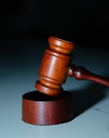 a wooden judge's hammer on top of a table