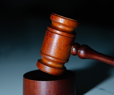a wooden judge's hammer on top of a table