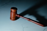 a wooden judge's hammer sitting on top of a table