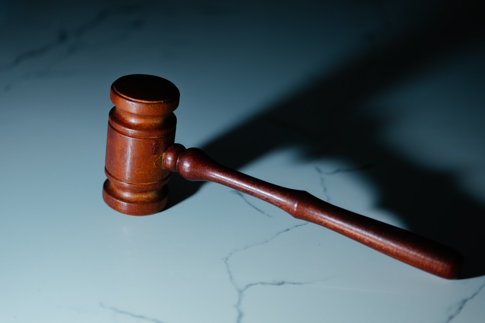 a wooden judge's hammer sitting on top of a table