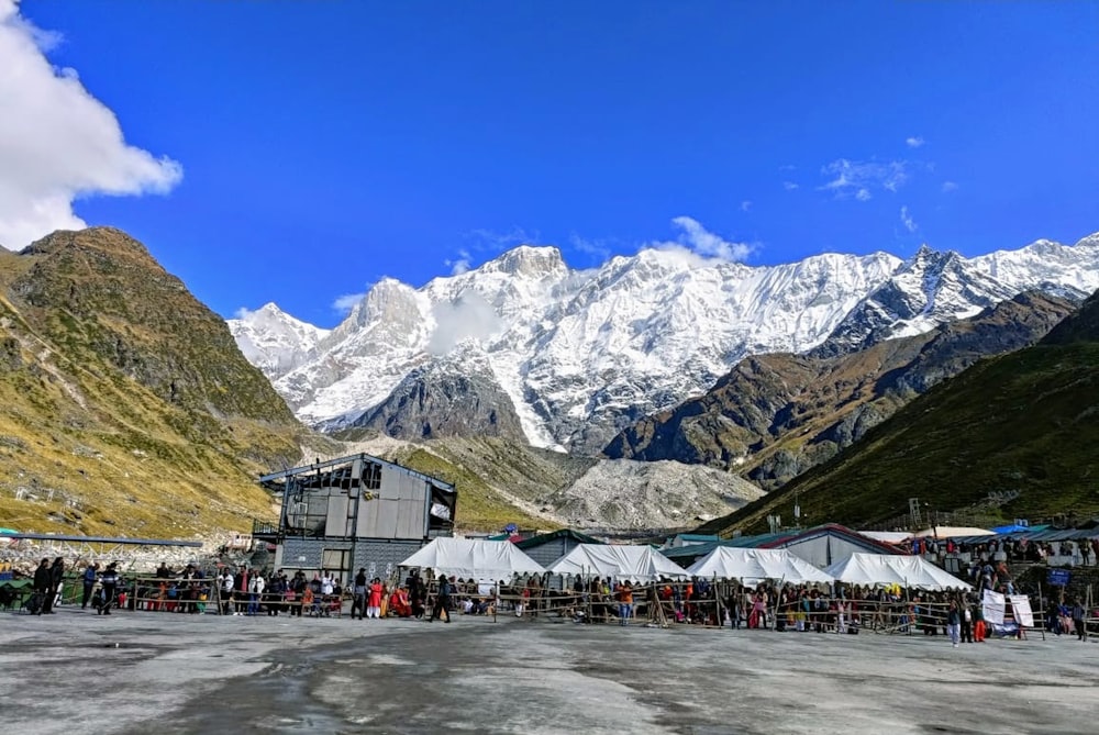 a group of people standing in front of a mountain