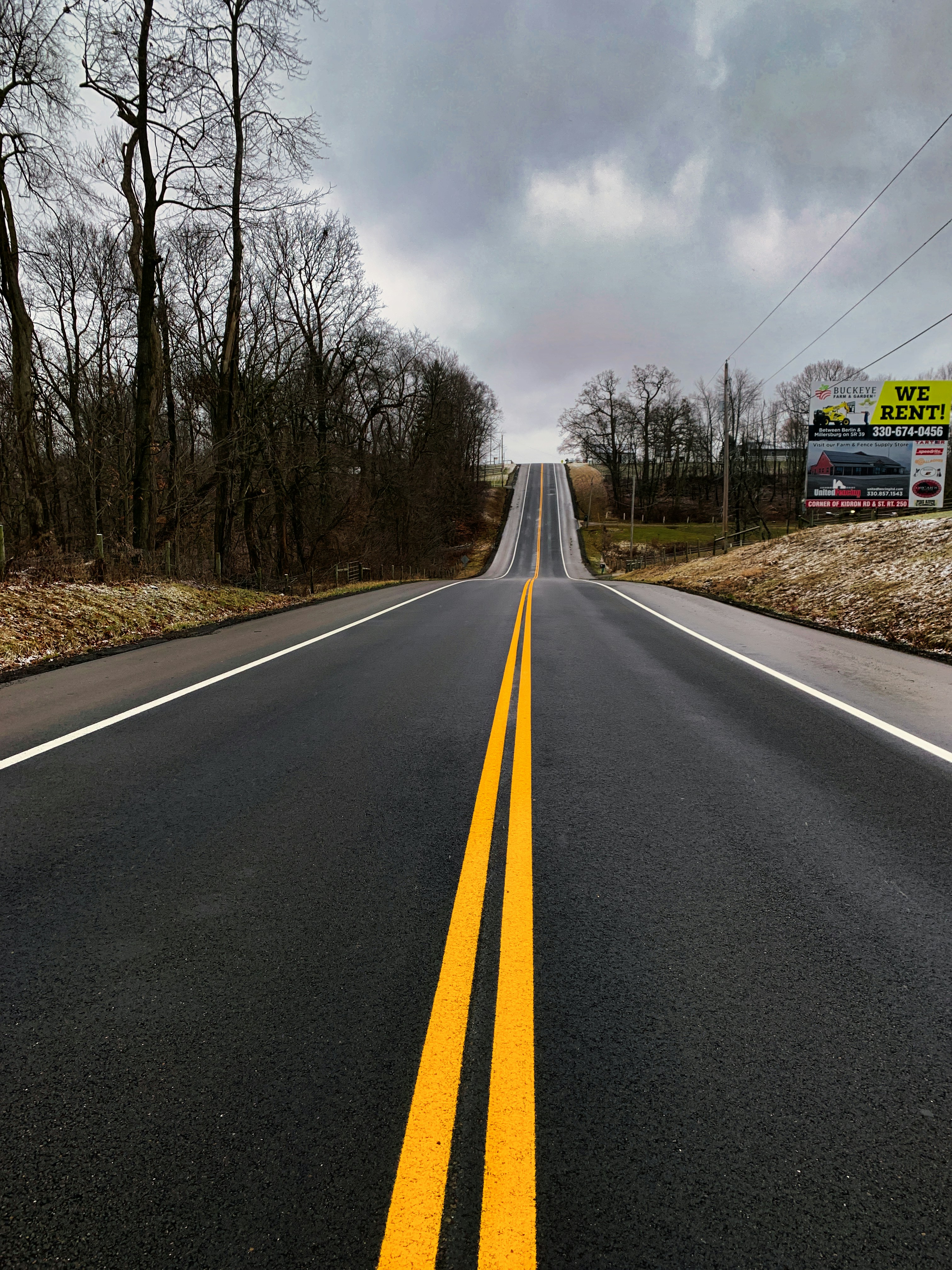 an empty road with yellow lines on it