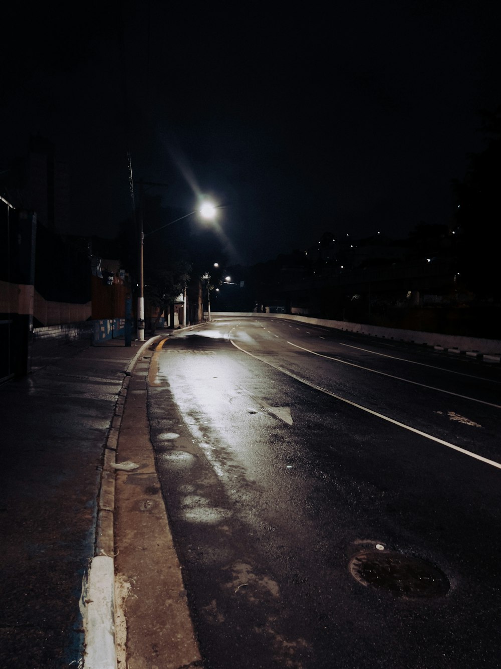an empty street at night with a street light