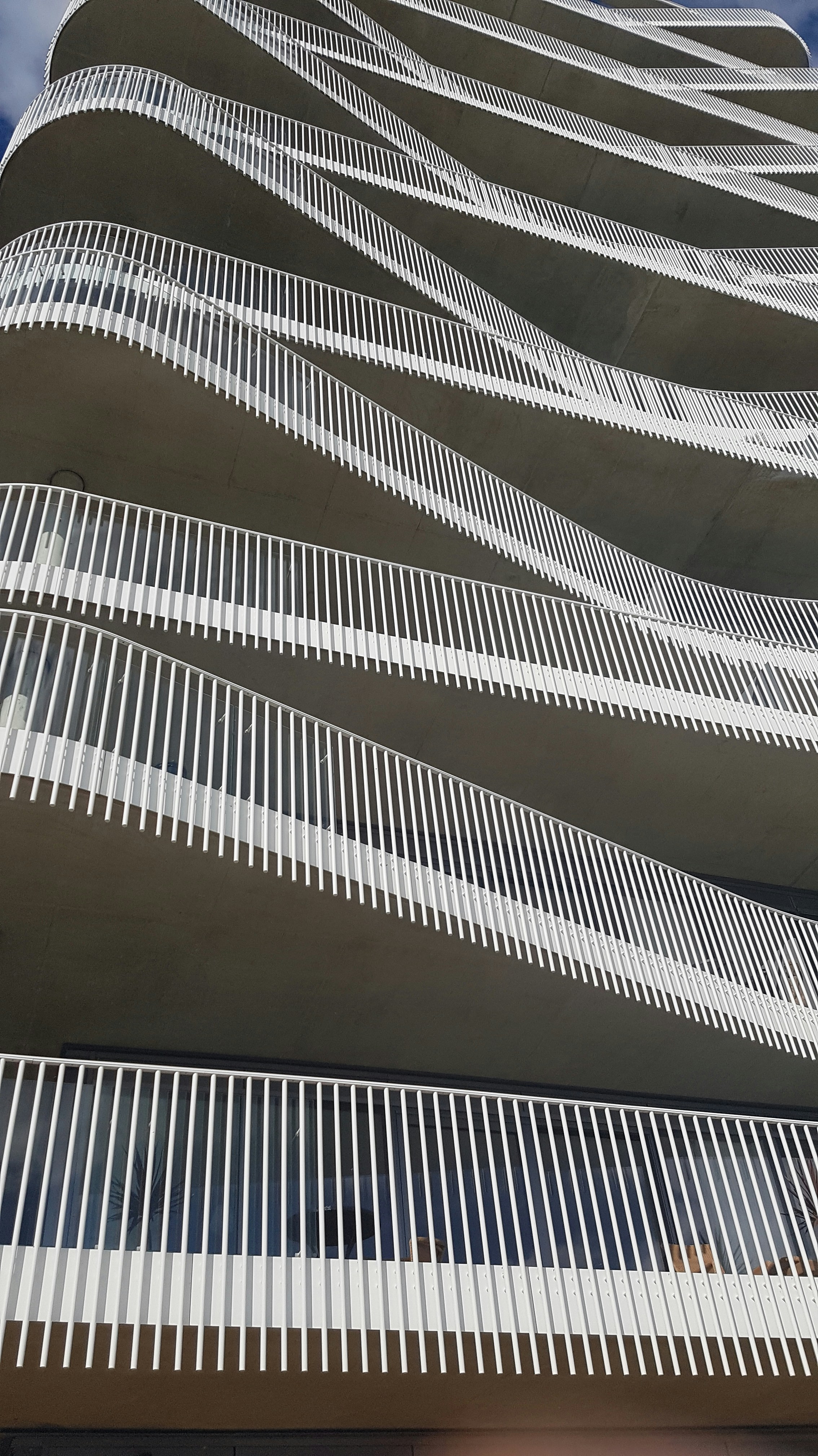 A very tall building with a bunch of white lines on it photo – Free ...