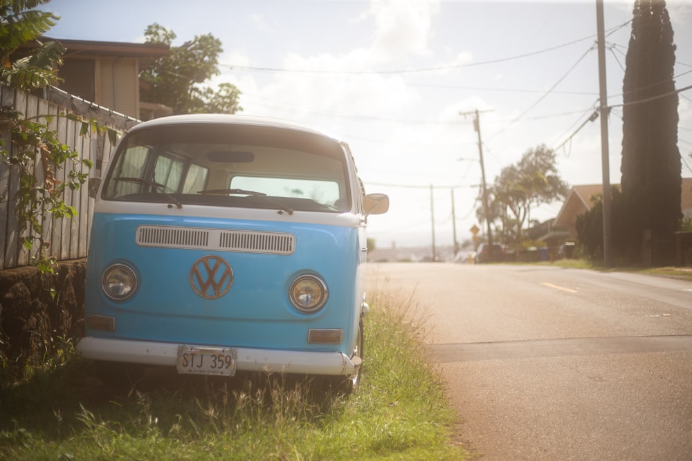 a blue and white van parked on the side of a road