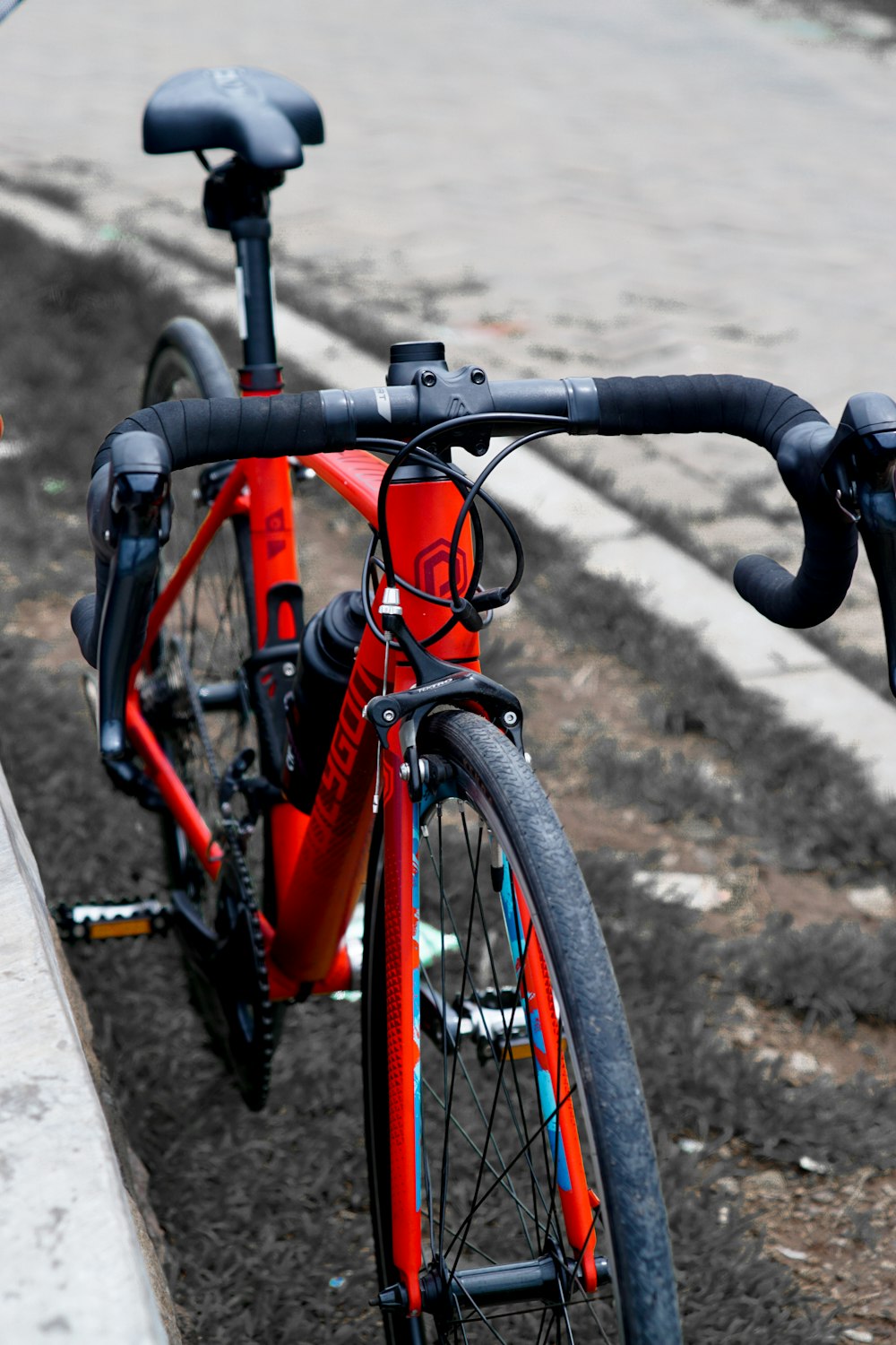 a red bicycle parked on the side of a road