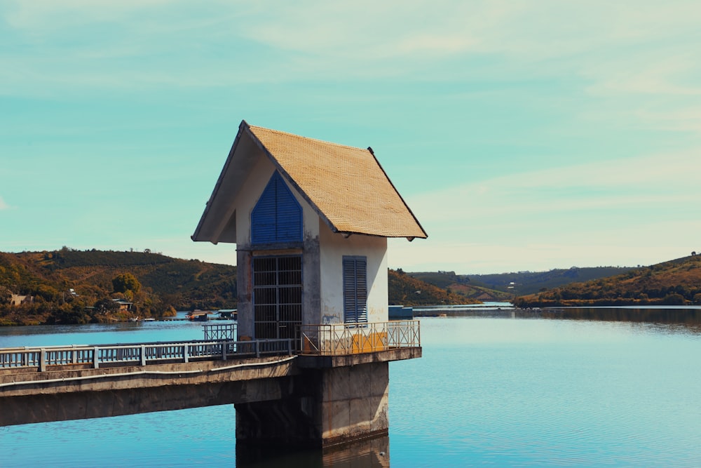 a small house sitting on top of a pier