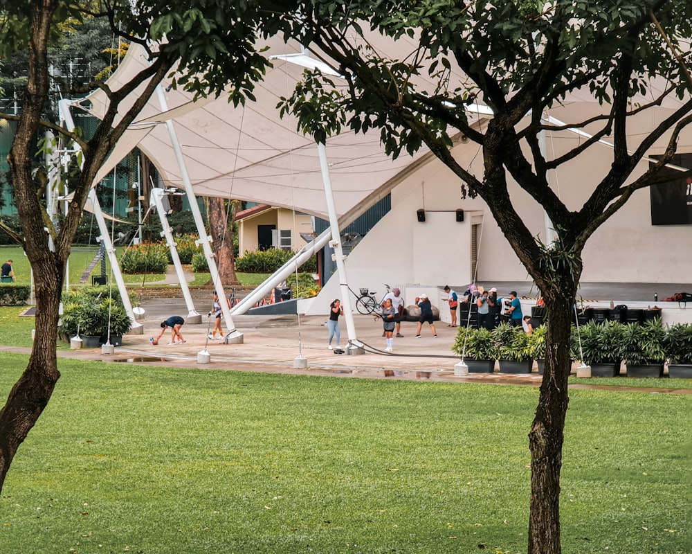 a group of people walking around a park