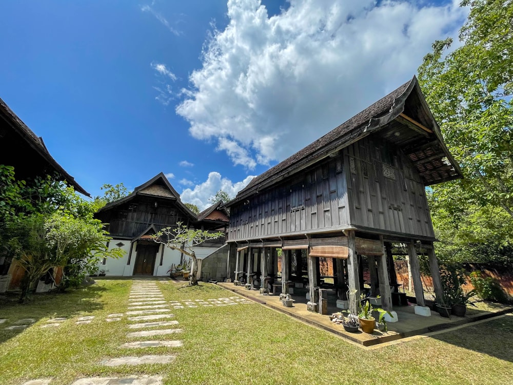 a large wooden building sitting on top of a lush green field
