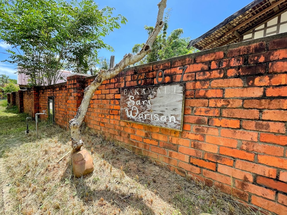 a brick wall with graffiti written on it