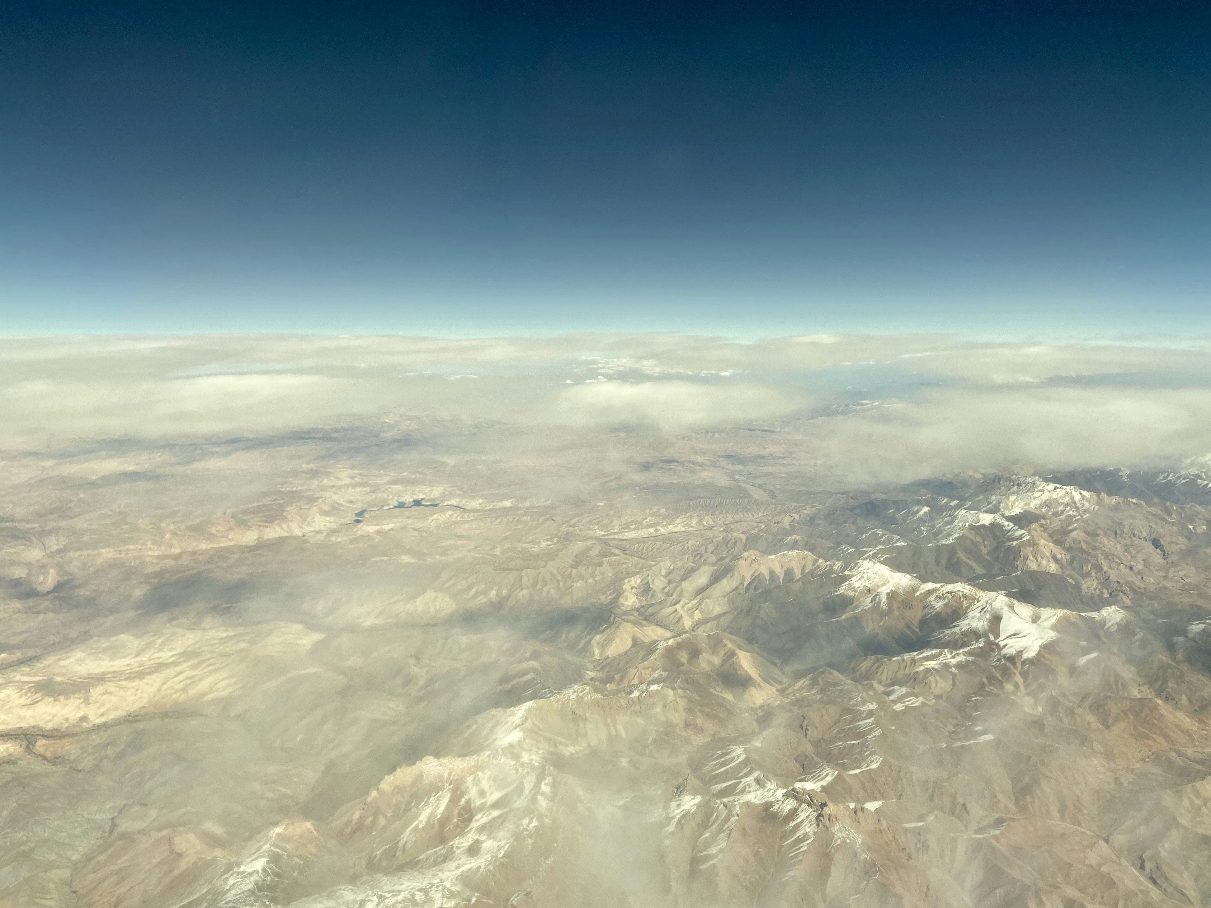 a view of a mountain range from an airplane, Afghan dessert mountains from the plane