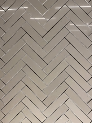An elegant tile installation pattern combining anti-skid and designer bathroom tiles.