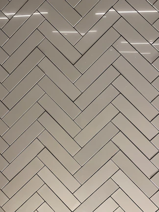 Modern kitchen floor with sleek gray LVP tiles arranged in a herringbone pattern.