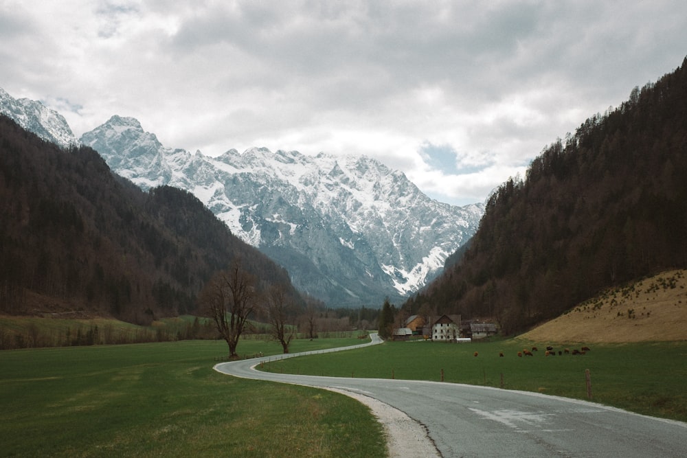 a winding road in the middle of a mountain valley