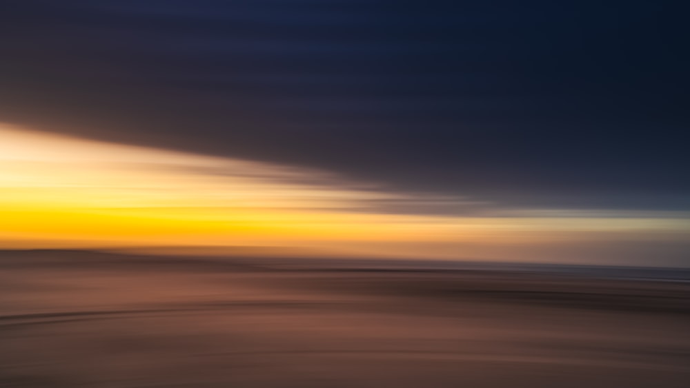 a blurry photo of a sunset over the ocean