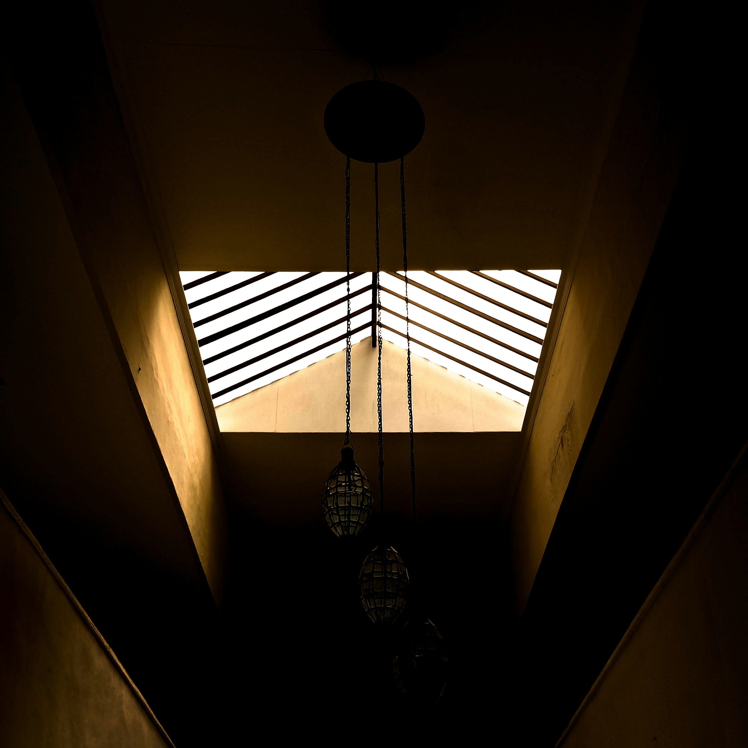 a hallway with a light fixture and a window