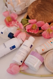 a table topped with lots of different types of skin care products