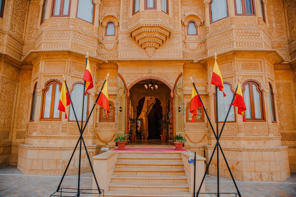 a large building with a bunch of flags in front of it