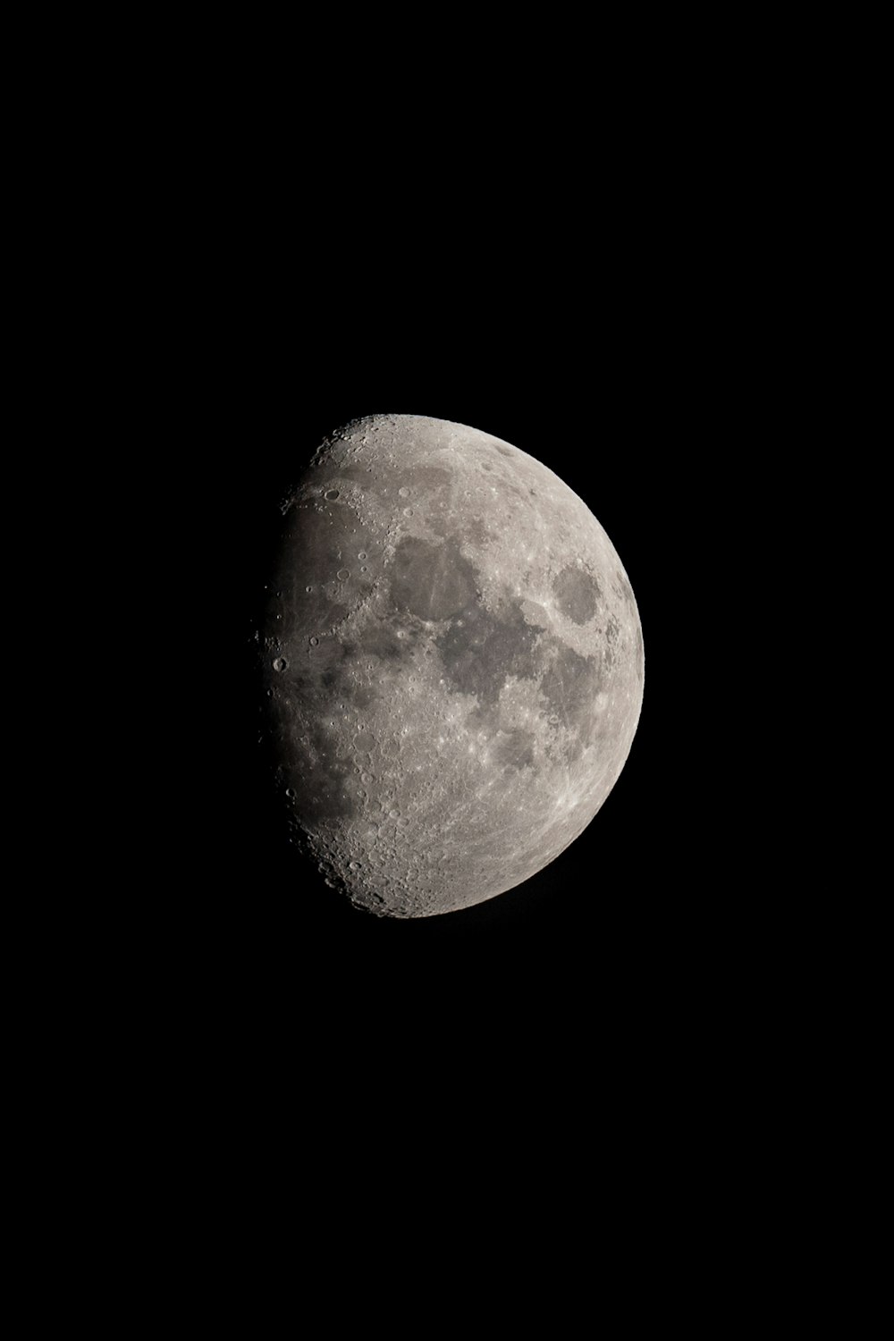 a full moon is seen in the dark sky