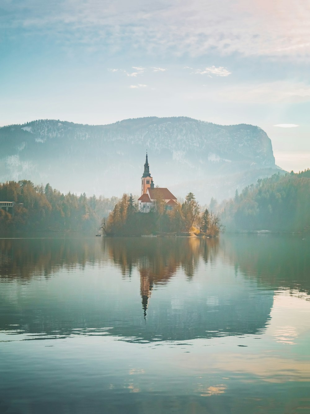 a church on a small island in the middle of a lake