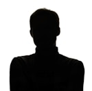 a silhouette of a man with his arms crossed