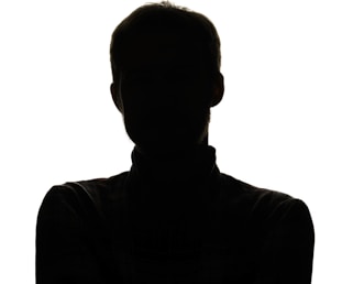 a silhouette of a man with his arms crossed