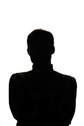 a silhouette of a man with his arms crossed