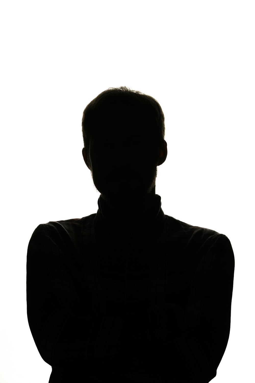 a silhouette of a man with his arms crossed
