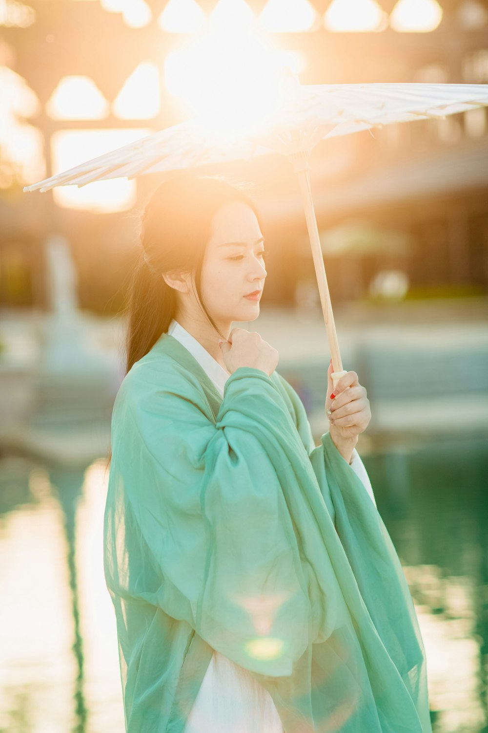 a woman in a kimono holding an umbrella