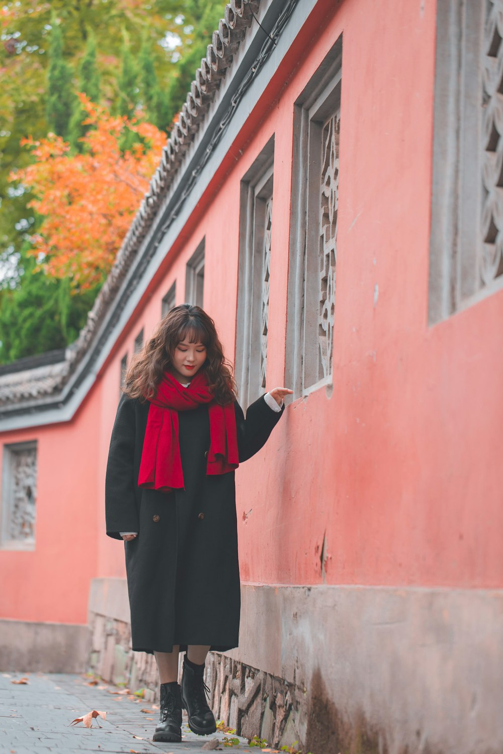 A woman in a black coat and a red scarf photo – Free Face Image on Unsplash