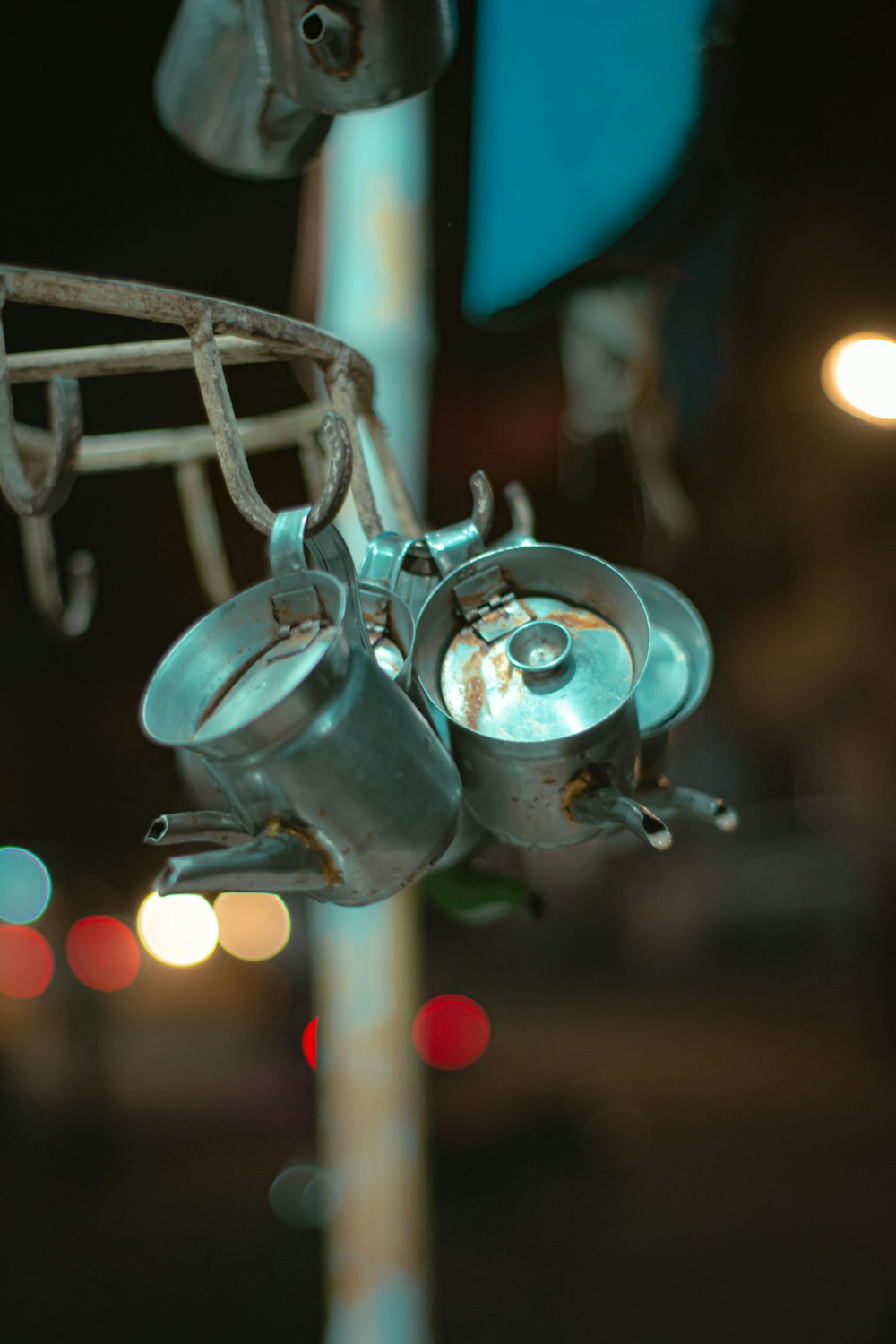 a metal pole with a bunch of cups hanging from it