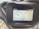 A digital screen displaying vehicle dashboard indicators. It shows two circular gauges; the left one depicts an engine temperature gauge with a water symbol, and the right one indicates a fuel gauge. The top left corner displays the hours used, reading 298.5 hrs, and the bottom shows a digital number 1720 with a lighting symbol beside it. The screen is surrounded by a black frame held in place by a bolt.