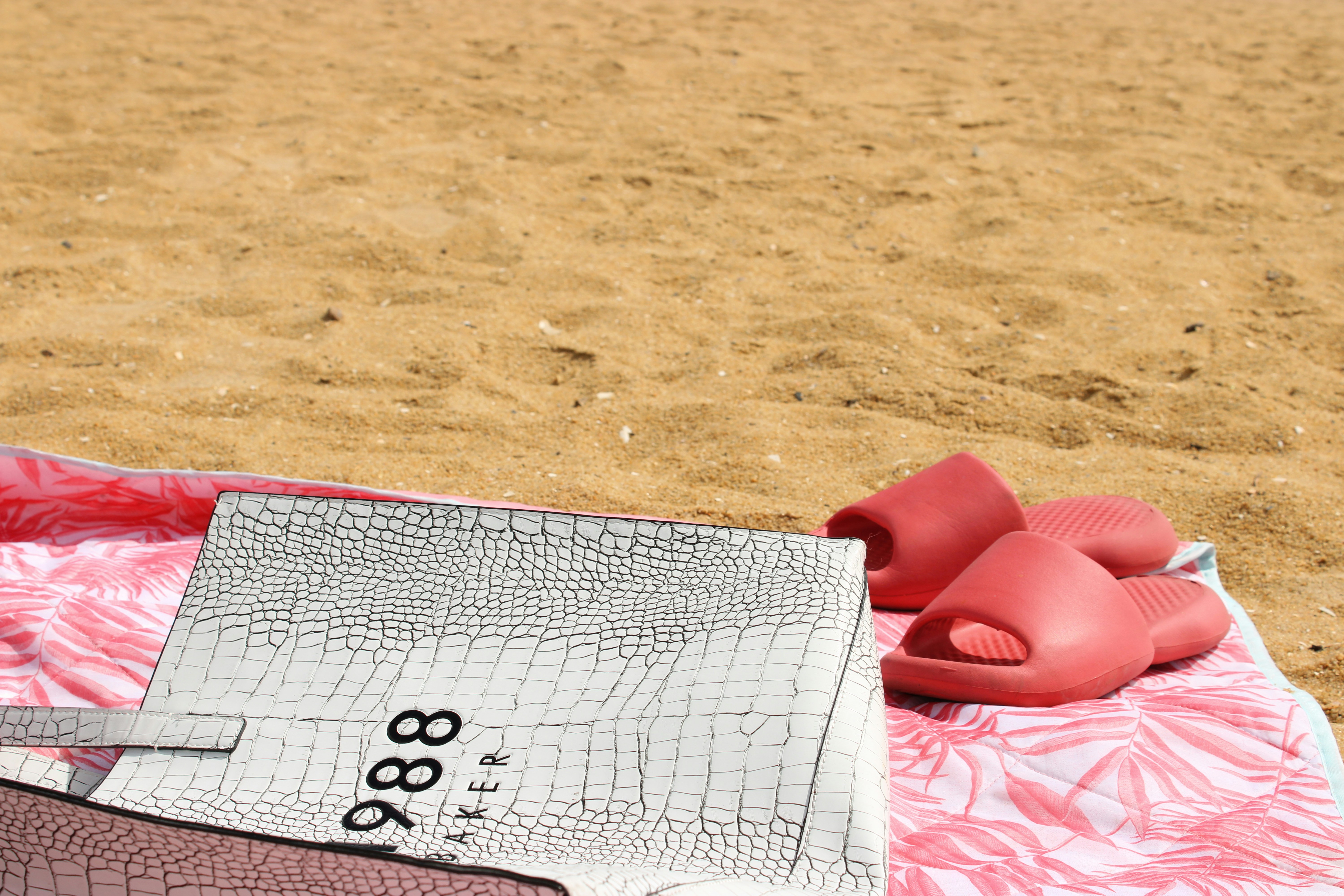 a pair of pink shoes sitting on top of a blanket