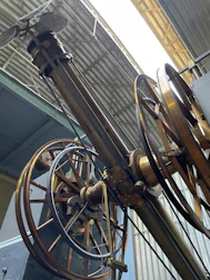 Heavy machinery parts connected with robust metal hinges in an industrial setting.
