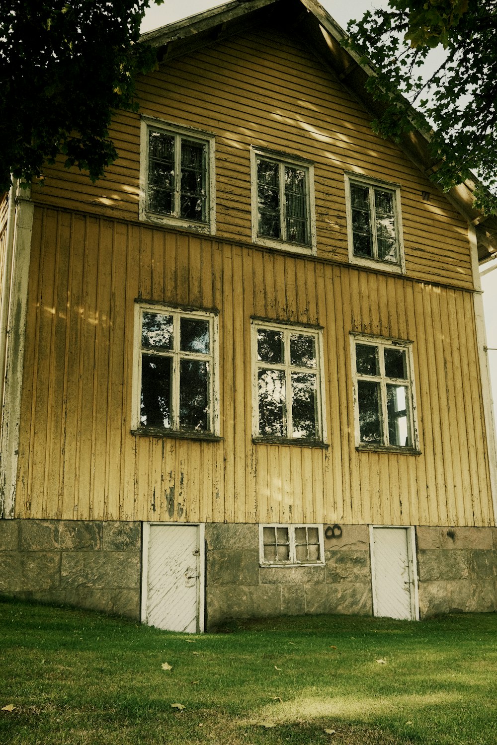 a yellow house with a white door and windows