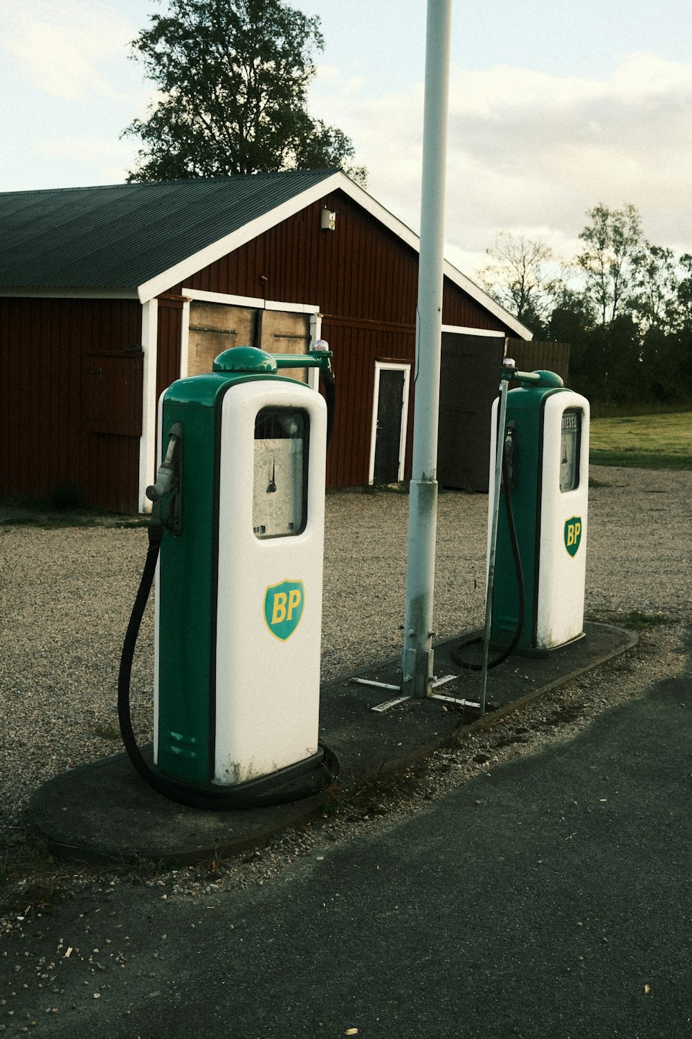 a couple of gas pumps sitting on the side of a road