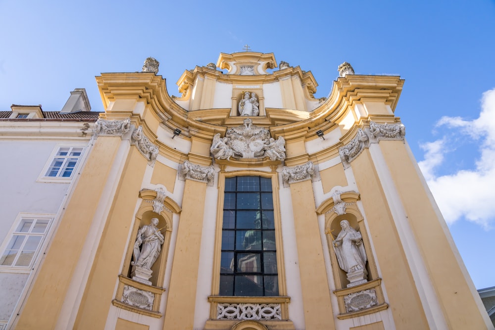 a tall building with statues on the front of it